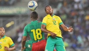 Ndumiso Mabena of South Africa challenged by Sebastien Clovis Siani of Cameroon during the 2017 AFCON Qualifier match between South Africa and Cameroon at Moses Mabhida Stadium, Durban Kwa-Zulu Natal on 29 March 2016 ©Muzi Ntombela/Backpagepix