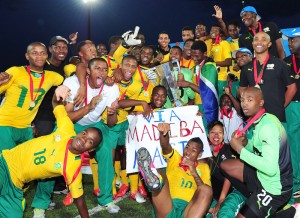 South Africa celebrate with their trophy after winning the Cosafa u20 Youth Championship Final between South Africa and Kenya at Setsoto Stadium, Maseru in Lesotho on 14 December 2013 ©Ryan Wilkisky/BackpagePix