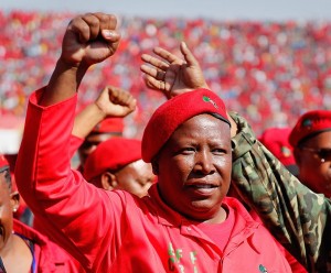 PRETORIA, SOUTH AFRICA - MAY 04: Commander and chief of the Economic Freedom Fighters and South African presidential candidate Julius Malema greets supporters as he enters the Lucas Moripe Stadium for an Economic Freedom Fighters presidential campaign rally at the Lucas Moripe Stadium on May 4, 2014 in Pretoria, South Africa. The rally comes prior to the South African presidential elections which are scheduled to be held on May 7, 2014. (J. Countess/Getty Images)